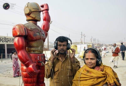 Hindu devotees wearing headsets listen to a fortune-telling machine at Sangam...